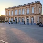 France and Bilderberg: 70 Years of Gallic Elite Influence in Secret Global Meetings (1954-2024) Wide establishing shot of the grand Trianon Palace Hotel in Versailles France with modern security b